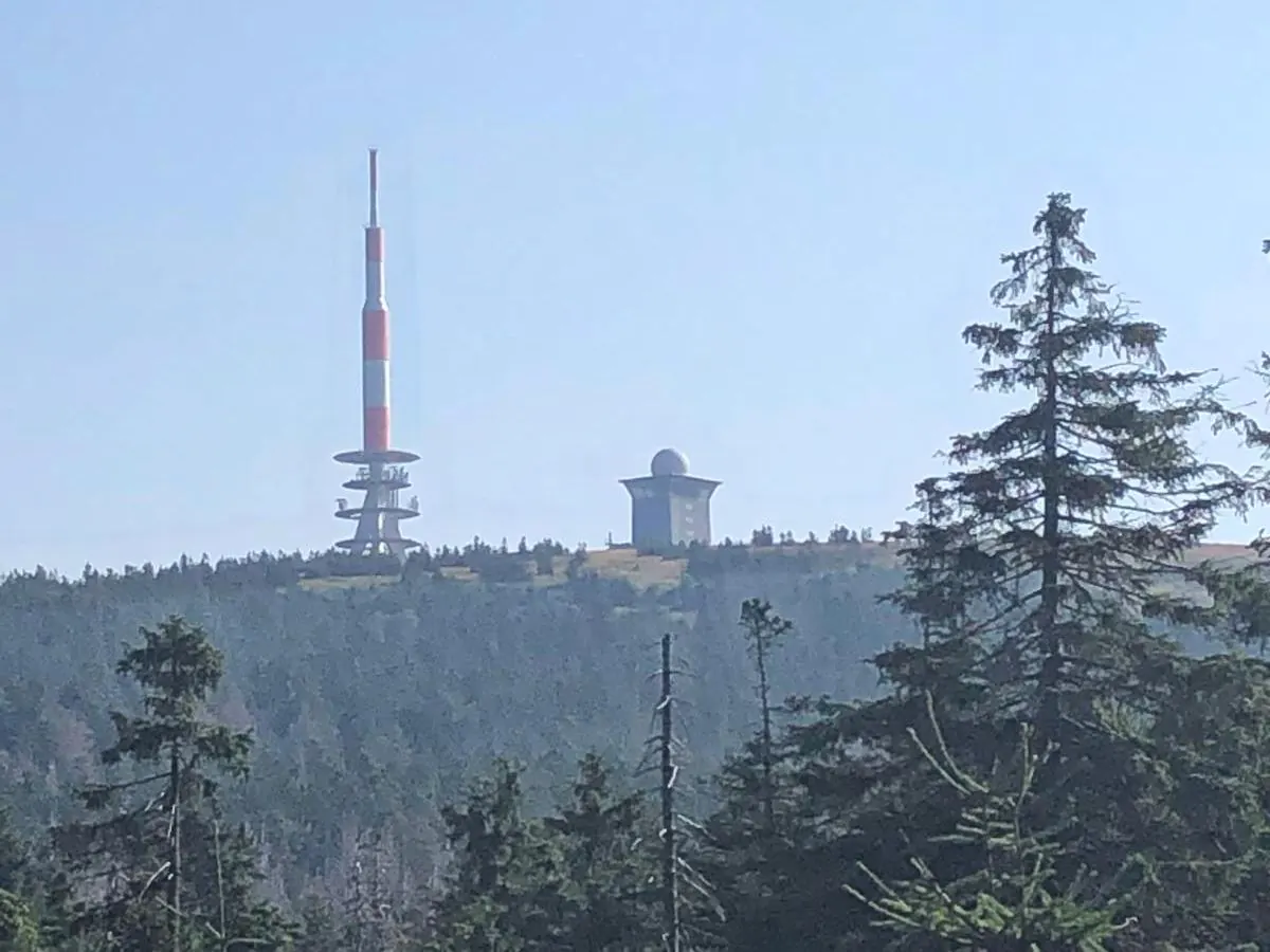 The Brocken with its transmitter mast and weather station above the forest
