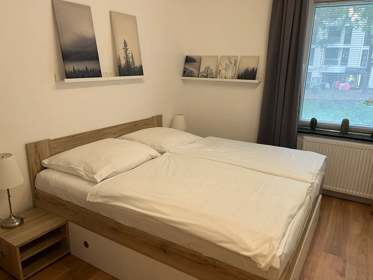 Bedroom with double bed and pictures above the bed